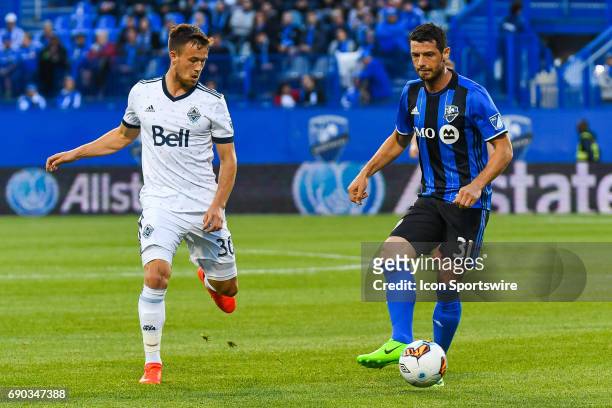 Montreal Impact midfielder Blerim Dzemaili chasing the ball closely followed by Vancouver Whitecaps midfielder Ben McKendry during the Montreal...