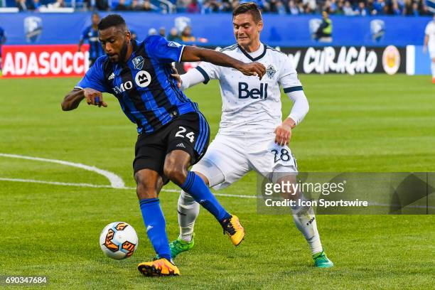 Montreal Impact forward Anthony Jackson-Hamel and Vancouver Whitecaps defender Jake Nerwinski fighting to control the ball during the Montreal Impact...