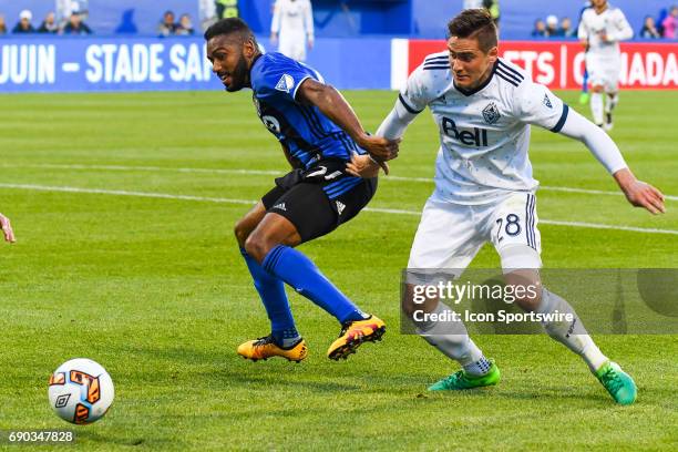 Montreal Impact forward Anthony Jackson-Hamel and Vancouver Whitecaps defender Jake Nerwinski fighting to control the ball during the Montreal Impact...