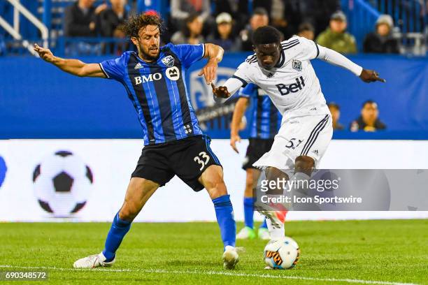 Montreal Impact midfielder Marco Donadel and Vancouver Whitecaps forward Alphonso Davies battling for the ball during the Montreal Impact versus the...