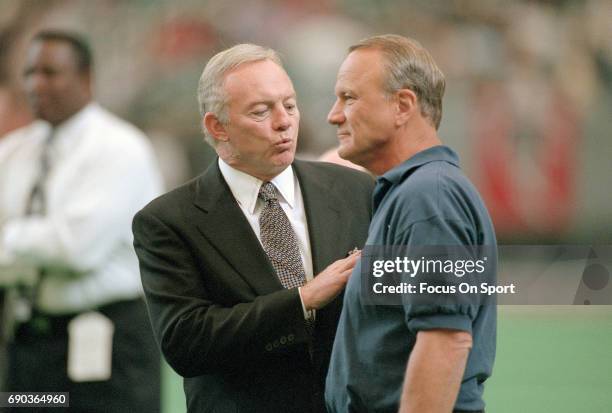 Owner Jerry Jones of the Dallas Cowboys talks with his head coach Barry Switzer while on the field prior to the start of an NFL football game circa...