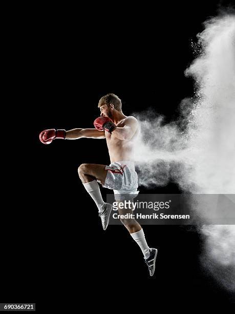 young man boxing in air with white powder - punching stock pictures, royalty-free photos & images