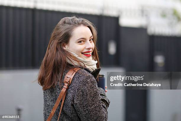 young woman walking in the street - winterjacke stock-fotos und bilder