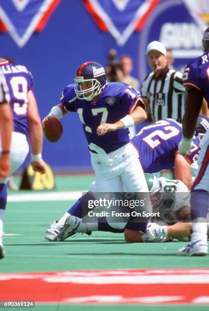 Dave Brown of the New York Giants gets tackled by Andy Harmon of the Philadelphia Eagles during an NFL football game September 4, 1994 at Giants...