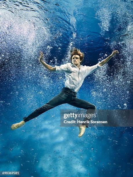 male ballet dancer underwater - male dancer blonde stock-fotos und bilder