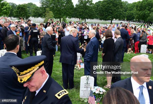 May 29: President Donald Trump, left center, talks to U.S. Secretary of Homeland Security John F. Kelly as people visit in observance of Memorial Day...