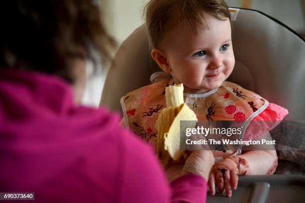 Val Whalen offers a banana to her granddaughter Elizabeth May 03, 2017 in Eldersburg, MD. Elizabeth, has a rare skin disease called Epidermolysis...