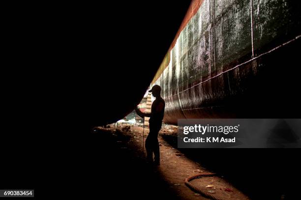 Young boy repairs an old ship during the Muslim biggest festival Eid al-Fitr in Bangladesh. Young labour get $4 USD for eight hour per day. Muslims...