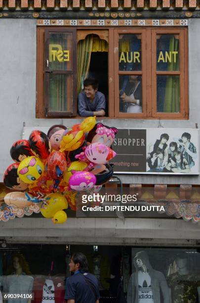 Bhutanese balloon seller waits for customers in Thimpu on May 31, 2017. Japanese Princess Mako is scheduled to arrive on a nine-day official visit to...