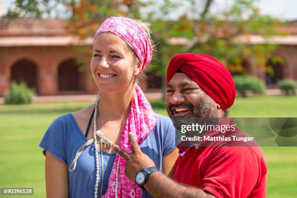 female visitor on a tour at the taj mahal - indian tour guide stock pictures, royalty-free photos & images