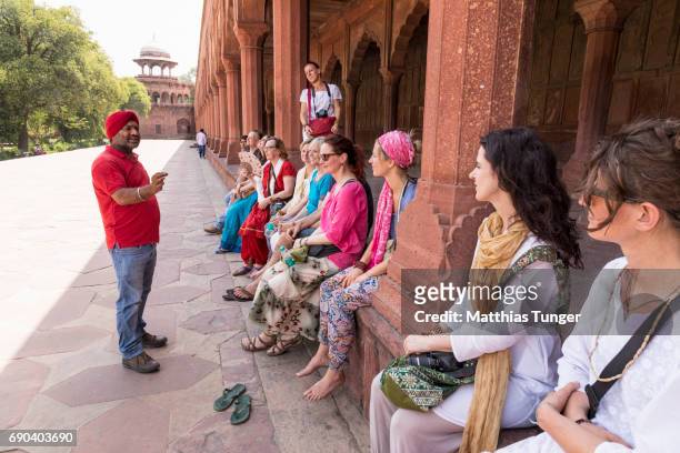 visitors on a tour at the taj mahal - explaining stock pictures, royalty-free photos & images