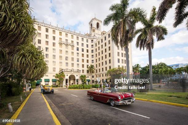 vintage convertible car in front of hotel nacional in havana, cuba - havana stock pictures, royalty-free photos & images
