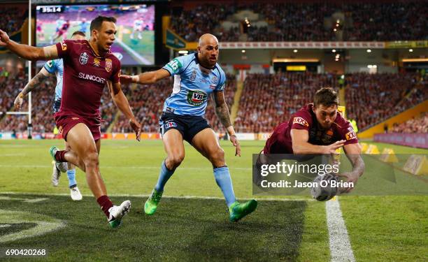 Corey Oates of the Maroons attempts to score a try during game one of the State Of Origin series between the Queensland Maroons and the New South...