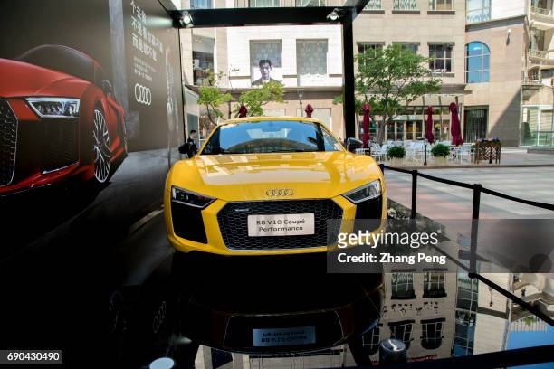 An Audi R8 V10 sports car exhibited on a shopping plaza. As the 2017 New York Auto Show kicked off, Audi officially launched Audi R8, a latest...