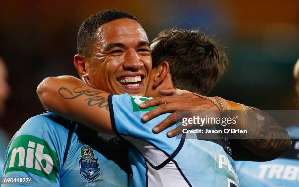 Mitchell Pearce and Tyson Frizell of the Blues celebrate during game one of the State Of Origin series between the Queensland Maroons and the New...