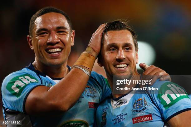 Mitchell Pearce and Tyson Frizell of the Blues celebrate during game one of the State Of Origin series between the Queensland Maroons and the New...