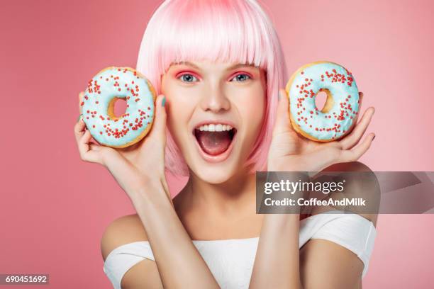 pretty blonde with multi-colored donuts - multi coloured nails stock pictures, royalty-free photos & images