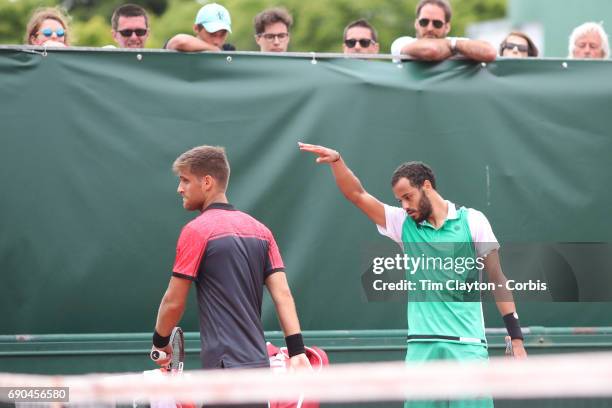 French Open Tennis Tournament - Day Three. Laurent Lokoli of France refuses to shake hands with winner Martin Klizan of Slovakia and waves him away...