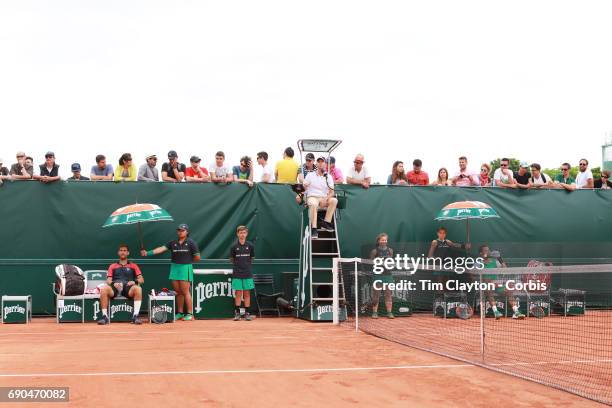 French Open Tennis Tournament - Day Three. Laurent Lokoli of France and winner Martin Klizan of Slovakia sit during an end change during a tension...