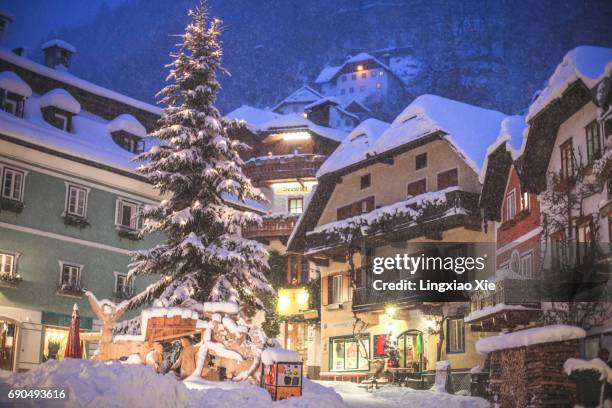 illuminated market square of hallstatt snowing at night, austria - christmas decoration outdoor stock pictures, royalty-free photos & images