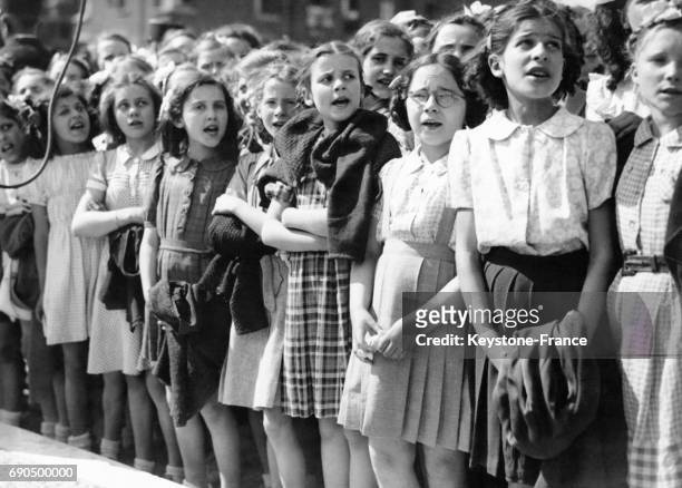 Un groupe de jeunes écoliers entonne l'hymne aux mères pendant la cérémonie devant le monument aux mères françaises boulevard Kellermann à Paris,...