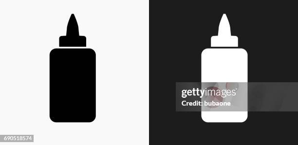 glue bottle icon on black and white vector backgrounds - glue stock illustrations