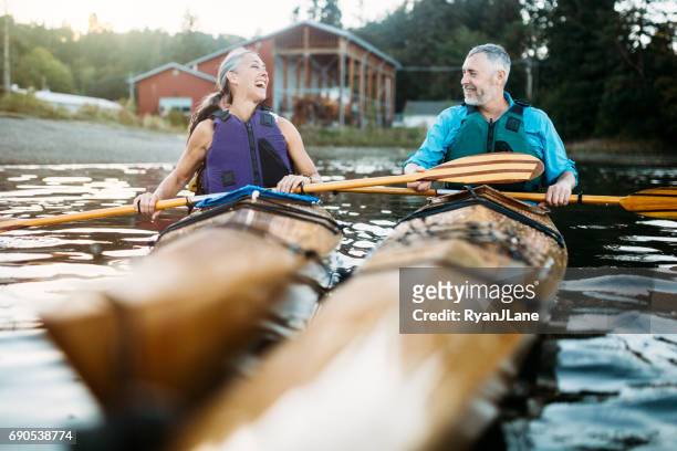 mature couple has fun kayaking - kayaking stock pictures, royalty-free photos & images