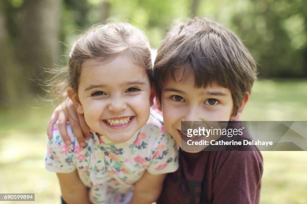 a brother and a sister posing together - sister photos et images de collection