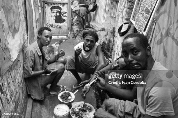 a group of friends have lunch in the in the suburbs of bujumbura, burundi. - eastern african tribal culture stock pictures, royalty-free photos & images