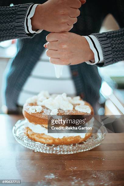 woman badly piping a cake - rekha garton stock pictures, royalty-free photos & images