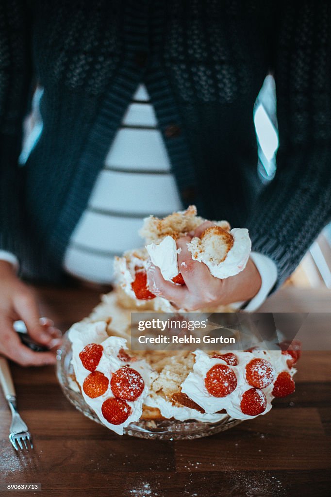 Woman holding a piece of cake