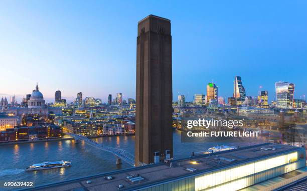 london skyline view at dusk of tate modern, st paul's cathedral, millennium bridge, river thames and the city, england, uk - millennium bridge londra foto e immagini stock
