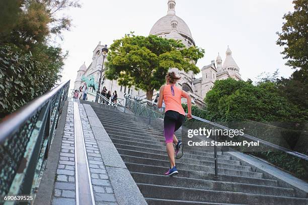 girl running up stairs near basilica sacre coeur - paris sport stock pictures, royalty-free photos & images