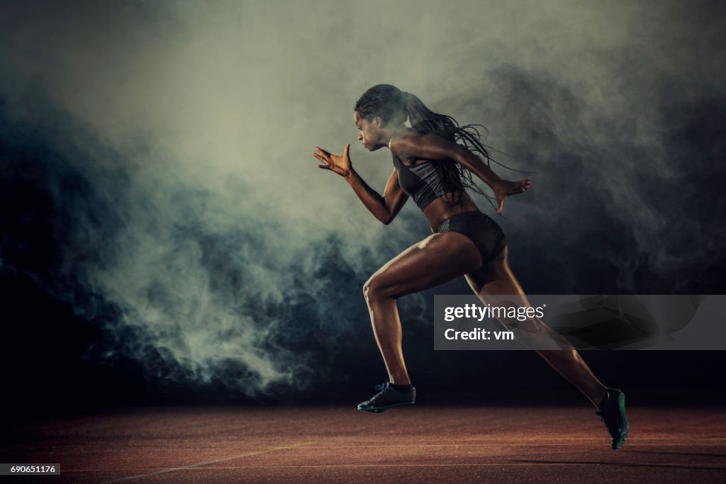 Female runner of African descent in mid-air