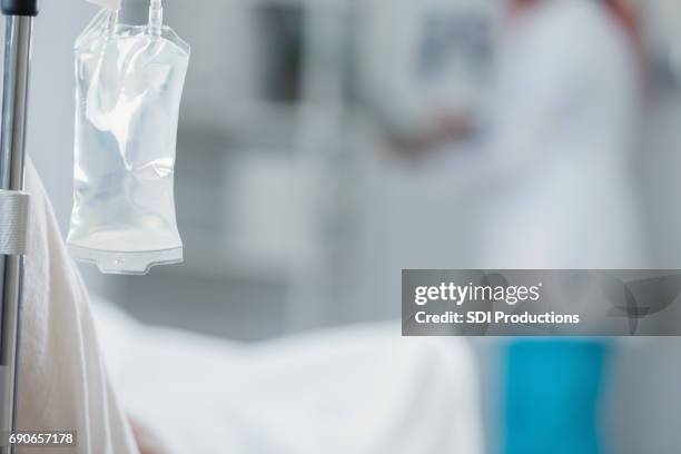 close up of iv drip in hospital room - critical care stock pictures, royalty-free photos & images