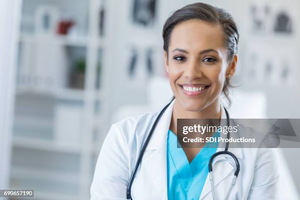 portrait of confident female healthcare professional - doctor white lab coat stock pictures, royalty-free photos & images