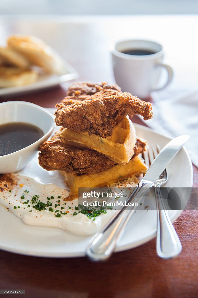 Chicken and waffles with syrup and crème fraiche