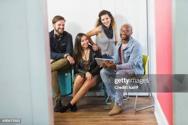 multi-ethnic group of young adults with digital tablet - on the outside looking in stock pictures, royalty-free photos & images