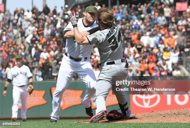 Bryce Harper of the Washington Nationals and Hunter Strickland of the San Francisco Giants throw punches at one another after Strickland hit Harper...