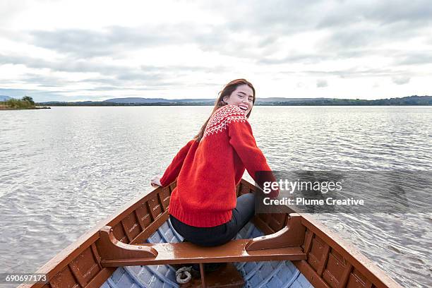 woman smiling in a row boat - scotland people stock pictures, royalty-free photos & images