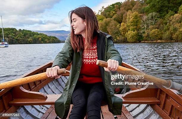 young woman in a row boat - rowboat bildbanksfoton och bilder