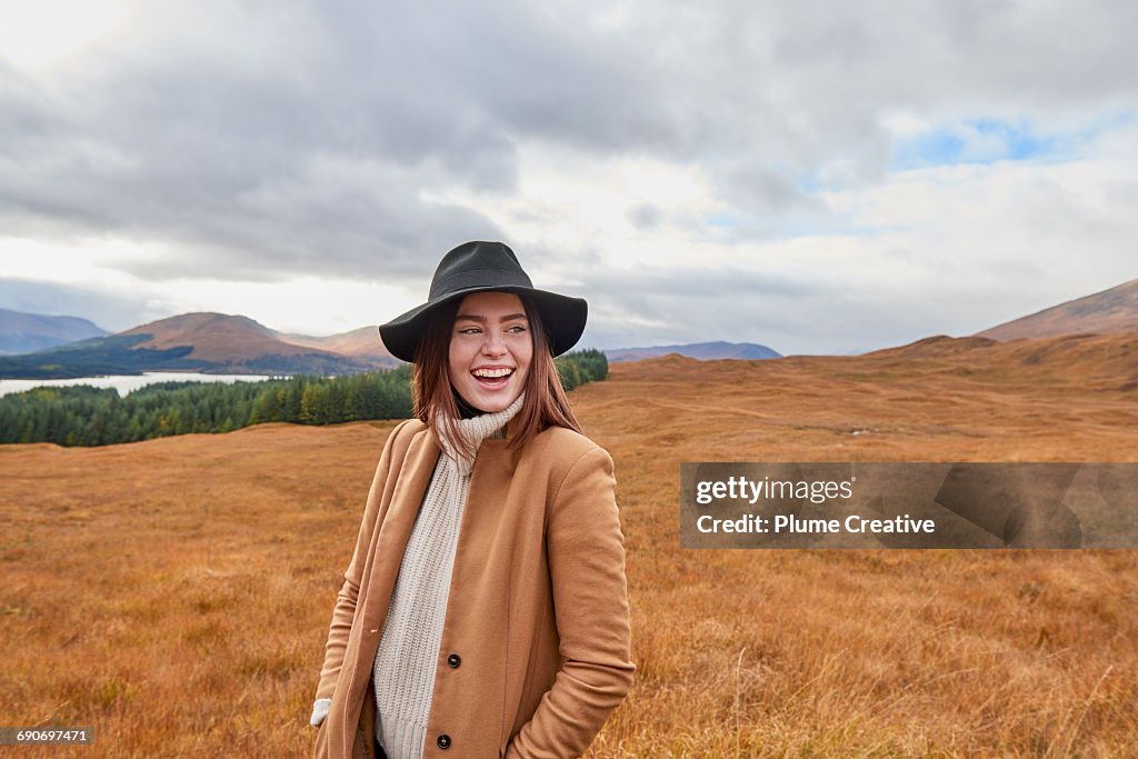 Woman laughing in Autumnal landscape