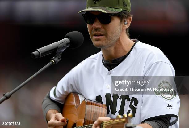 Former San Francisco Giants Barry Zito performs playing the guitar and singing prior to the start of a Major League Baseball game between the San...