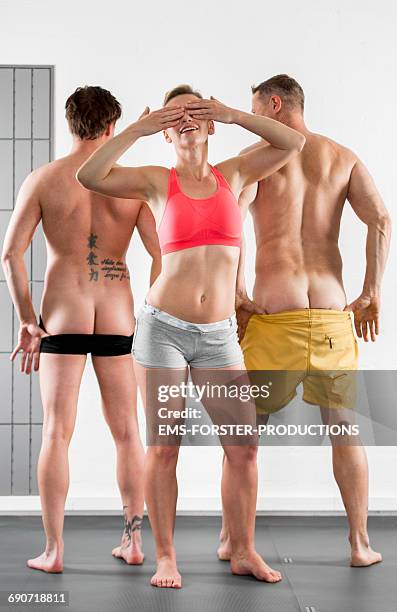 sporty woman and two sporty men - women mooning stockfoto's en -beelden