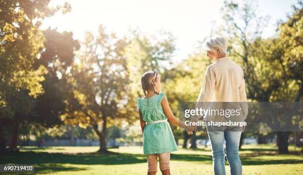 i'll always be there to hold your hand - multi generation family from behind stock pictures, royalty-free photos & images