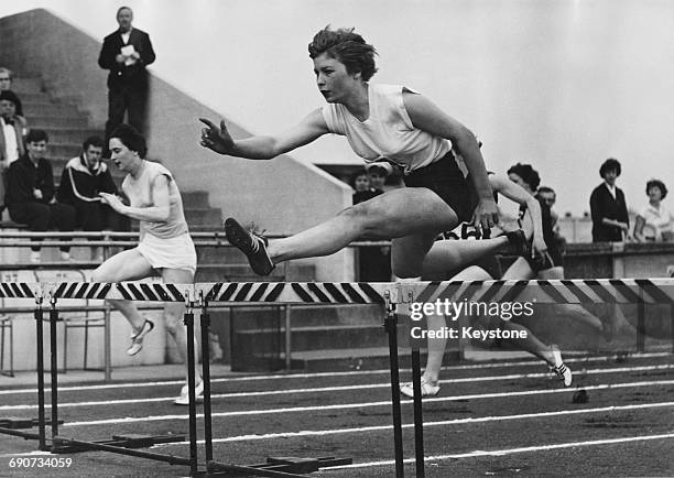 English track and field athlete Mary Bignal, later Mary Rand, during a hurdling event, February 1960.