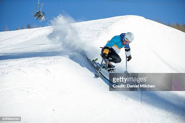 guy with differing abilitie riding a half-pipe. - wintersport stock-fotos und bilder