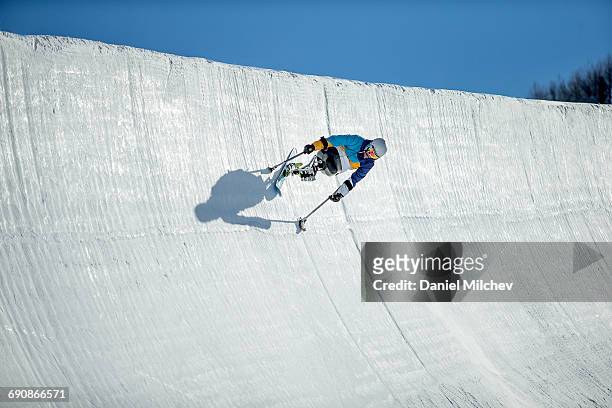 guy on a wheelchair sled riding a super pipe. - half pipe stock pictures, royalty-free photos & images