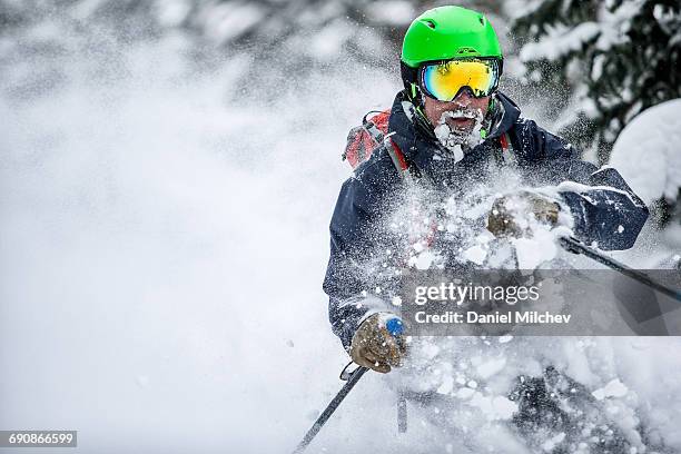 skier with frosty beard going through deep snow. - professional skier stock pictures, royalty-free photos & images