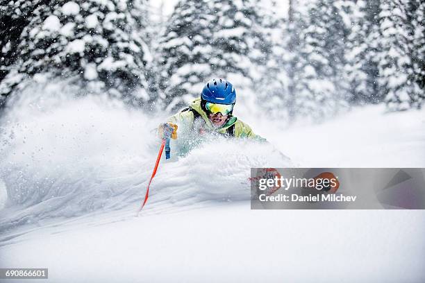 skier makig aggressive turn in deep snow. - powder snow stock pictures, royalty-free photos & images